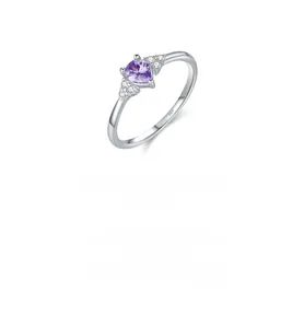 Detail of s925 silver ring featuring a purple pear-shaped crystal with side zirconia stones