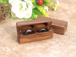 Detail of walnut wood double ring box with black velvet lining and magnetic closure