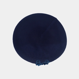 Detailed close-up of dark blue wool knitted beret showing floral rhinestone embroidery texture