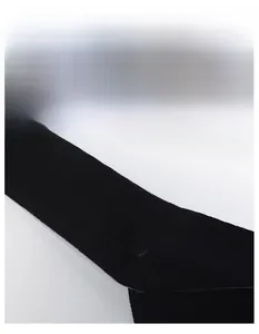 Detail of black moisture-wicking sweatband showing elastic knitted texture and wide design