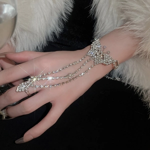Macro view of sparkly butterfly hand harness featuring silver metal and rhinestones