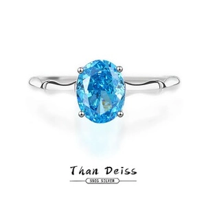 Macro shot of S925 sterling silver ring with blue oval gemstone and bamboo design band