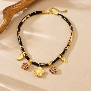 Retro leopard print flower necklace with gold moon and camellia charms on woven cord