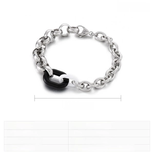 Détail du bracelet gourmette en acier inoxydable avec des maillons en résine noir et blanc