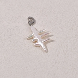 Macro shot of an irregular baroque pearl pendant with a sparkling diamond-set silver clasp