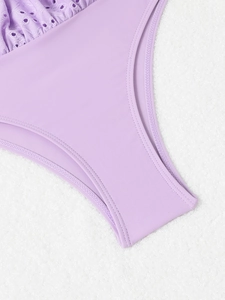 Detail of lavender swimsuit featuring eyelet lace trim and high-elasticity fabric texture
