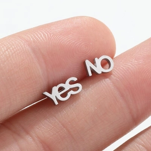 Retro stainless steel asymmetric Yes NO letter stud earrings shown on finger for scale