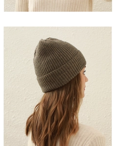 Detail view of a tan ribbed knit beanie showing high-quality texture and warm fit