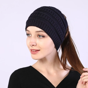 Detail of navy blue ribbed knit headband with ponytail hole and elastic texture