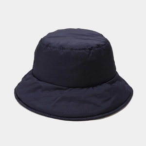 Detail view of navy blue padded down bucket hat with warm winter insulated texture