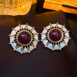 Vintage French style sunflower stud earrings with red gemstones on brown velvet
