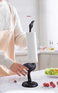 Detailed close-up of a cast iron bird paper towel holder in a modern kitchen setting