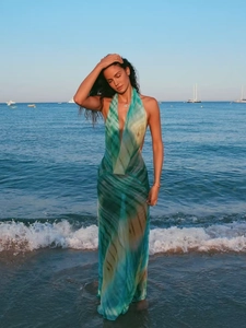 Detail of teal tie-dye beach maxi dress featuring a deep V-neck and open back design