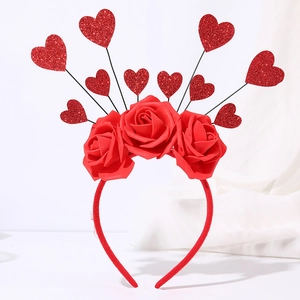 Close-up of red foam roses and sequined heart accents on a festive headband decoration