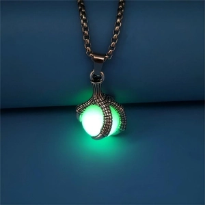 Detailed view of vintage dragon claw necklace with a glowing green luminous stone