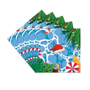 Fan-shaped stack of summer Christmas napkins with tropical palm and beach ball prints