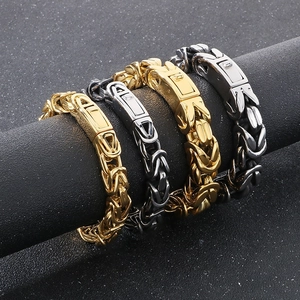 Detail of gold and silver Byzantine chain bracelets with box clasps on black display