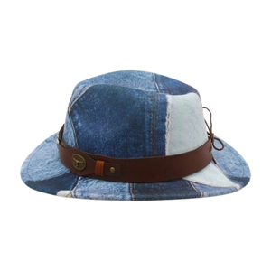 Detail of western cowboy hat with patchwork denim fabric and bull head metal buckle icon