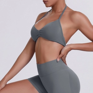 Detail of grey seamless halter sports bra and high waist shorts yoga set on model