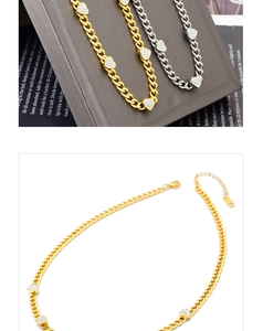 Detailed view of gold and silver chunky chain necklaces with pavé heart charms and lobster clasp