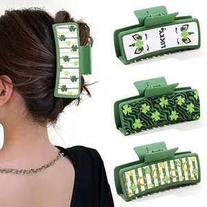 Detail showing green St. Patrick's Day hair claws with lucky clover and horse shoes