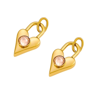 Macro shot of gold-plated heart-shaped padlock charms with pink zircon inlay details