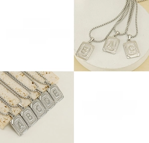 Detailed close-up of square stainless steel alphabet pendant necklace with etched rays