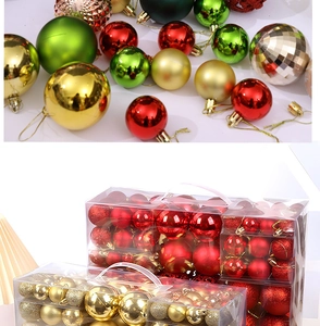 Close-up of red, green, and gold Christmas ornaments in shiny and glitter finishes