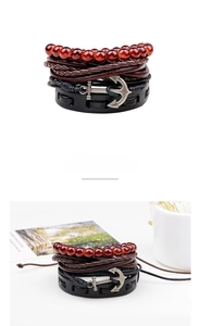 Nautical leather bracelet set with red beads, braided cords, and a vintage silver anchor