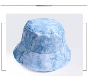 Detail view of the tie-dye bucket hat showing blue and white cotton twill fabric texture