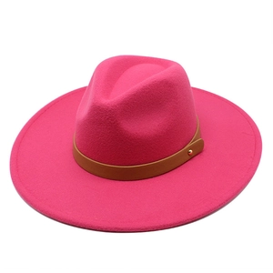 Detail of rose pink wool fedora hat with brown leather band and gold rivet accent