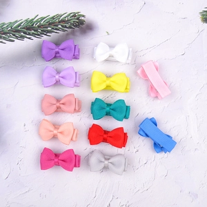 Flat lay of colorful fabric bow hair clips for girls on a marble surface background