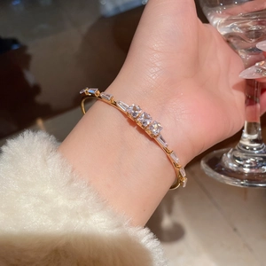 Detail view of 18K gold plated cuff bracelet with sparkling square-cut cubic zirconia
