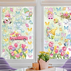 Spring gnomes and floral window clings set with butterflies and pink truck on glass surface