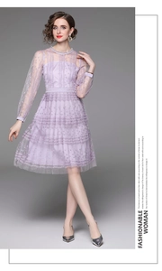 Close-up of purple lace dress detailing intricate floral patterns and sequin embroidery