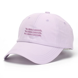 Detail of lavender baseball cap showing textured fabric and wavy embroidery on the front