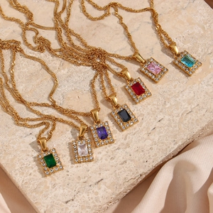 Macro view of square colorful zircon pendants on water wave chain with silk background