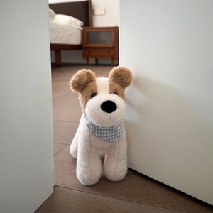 Cute Fox Terrier plush puppy with blue checkered scarf peeking through an open door