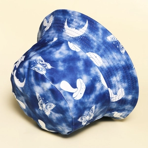 Tie-dye reversible bucket hat with white butterfly, moon, and mushroom prints