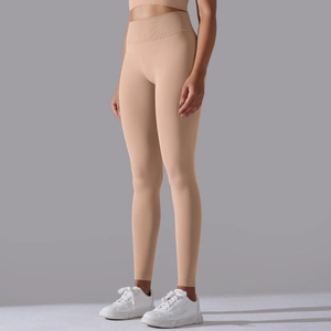 Detail of high waisted seamless ribbed yoga leggings in nude pink for fitness training