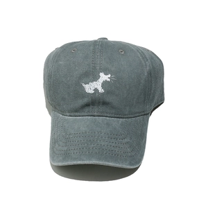 Detail view of washed cotton baseball cap with white dog silhouette and vintage texture