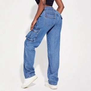 Detail view of American vintage blue cargo jeans with functional side flap pockets