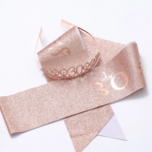Detail of rose gold 30th birthday set including glitter sash and rhinestone tiara
