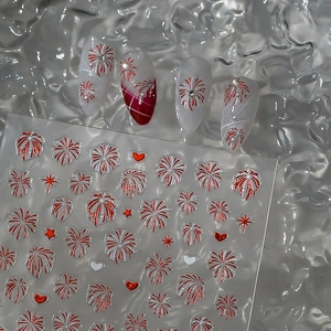 Macro detail of red metallic firework and star nail stickers on elegant silver background