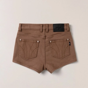 Rear view of brown denim shorts featuring back pockets and black leather logo patch
