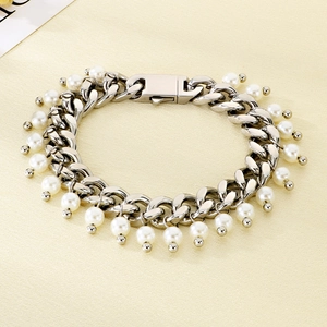 Silver Cuban chain bracelet with white pearl pendants and a folding clasp detail