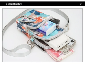Macro view of floral Oxford fabric phone bag showing three zipper compartments and storage