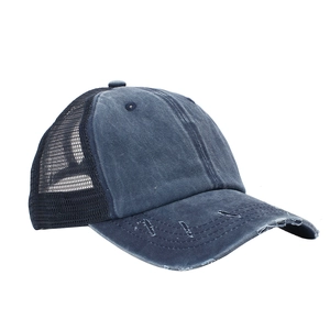 Close-up of navy washed distressed denim baseball cap with black mesh back and curved brim