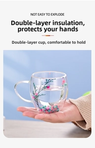 Detail of double-walled glass cup with dried flowers and ergonomic handle