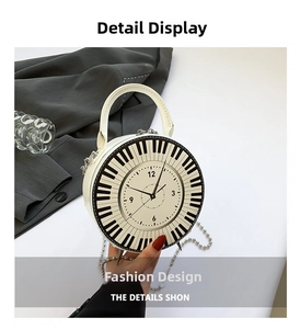 Detail shot of round piano-themed crossbody bag with clock face dial and chain strap